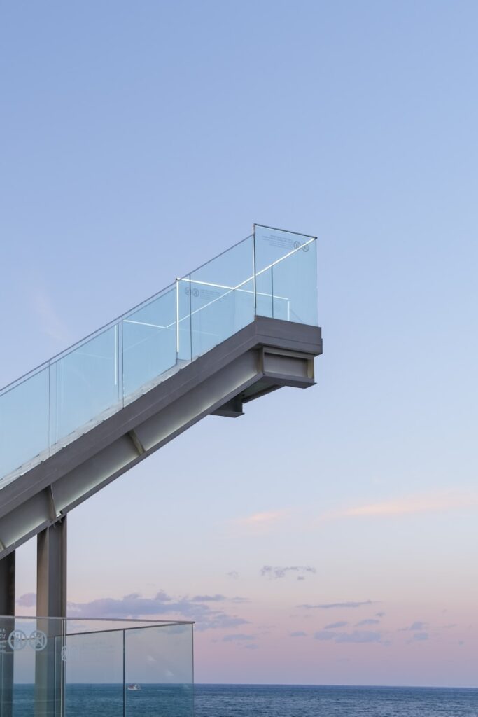 gray metal bridge under blue sky during daytime